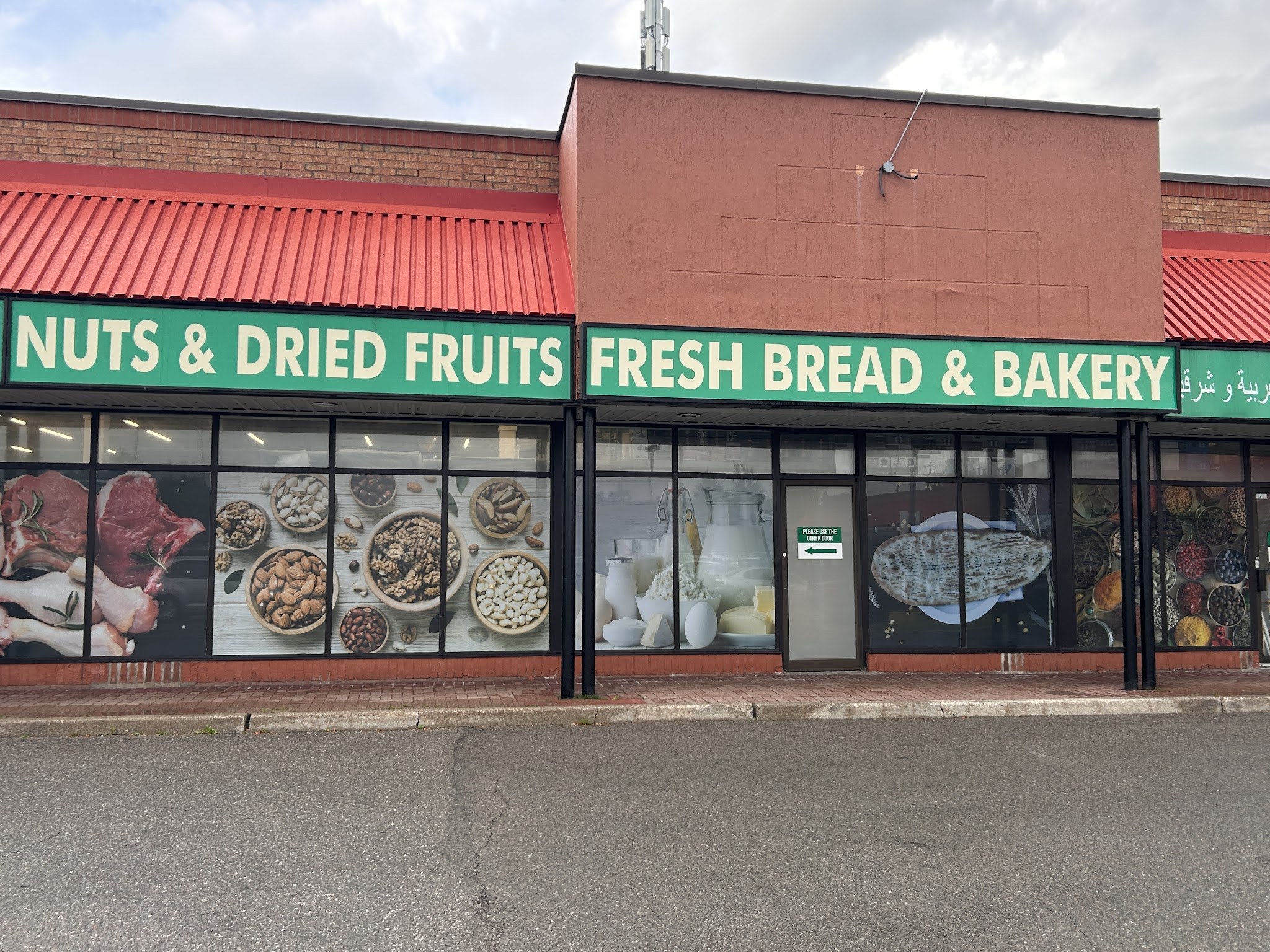 Kabul Farms storefront showing Nuts and Dried Fruits and Fresh Bread and Bakery signage