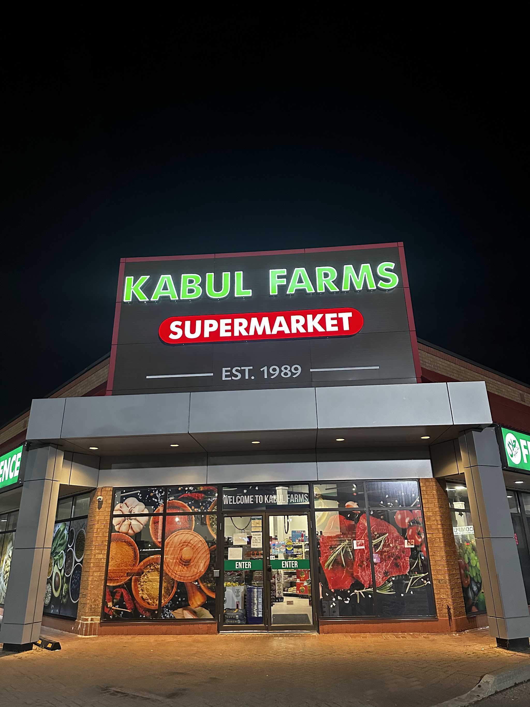 Kabul Farms Supermarket storefront illuminated at night