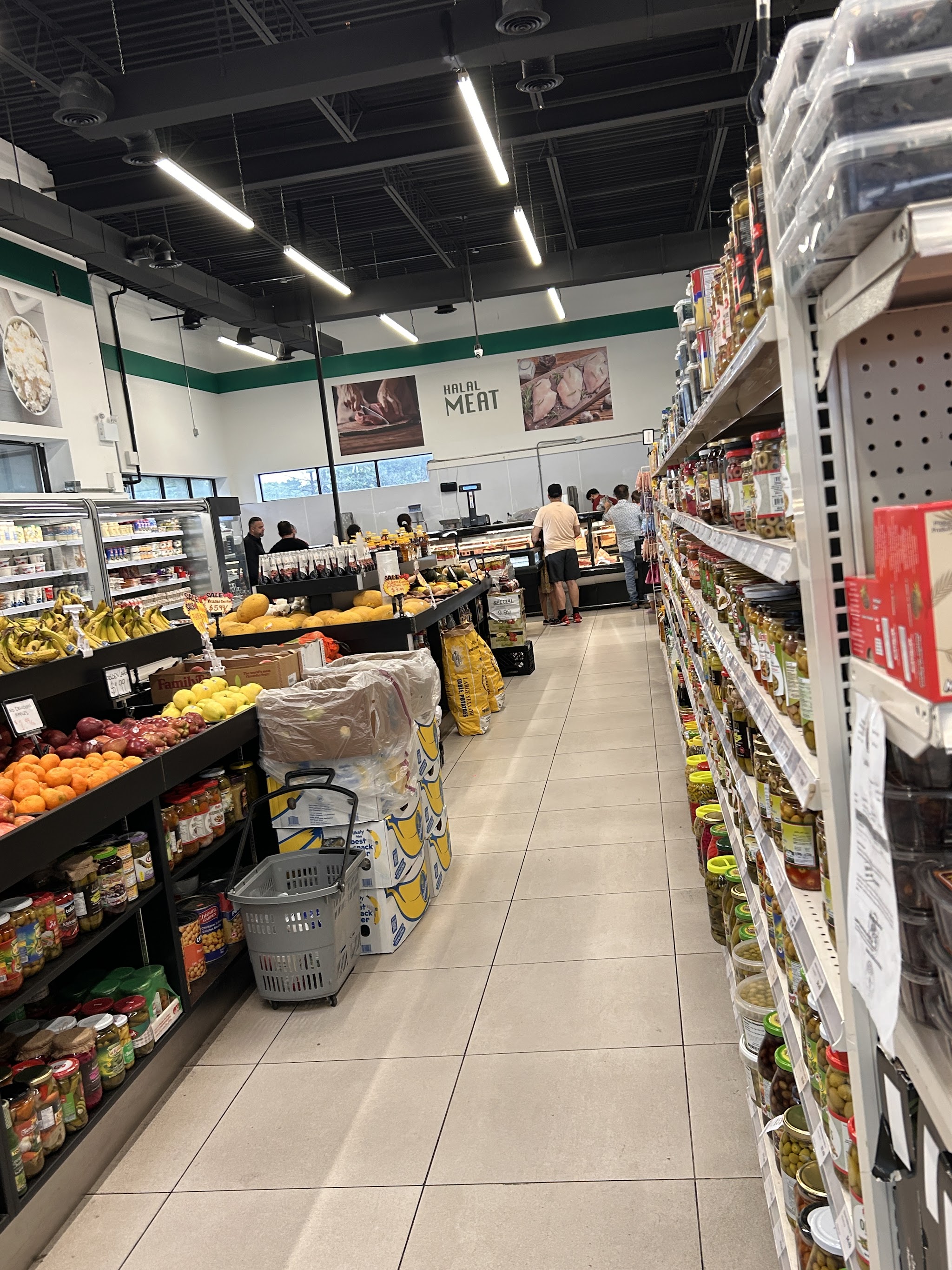Interior view of Kabul Farms showing spacious, well-stocked aisles with fresh produce and grocery items